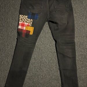 AMIRI Black Skinny Jeans with Vibrant Patches